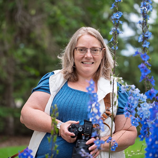 Catriona Hope holding her camera outdoors in Sherwood Park near Edmonton, Alberta.