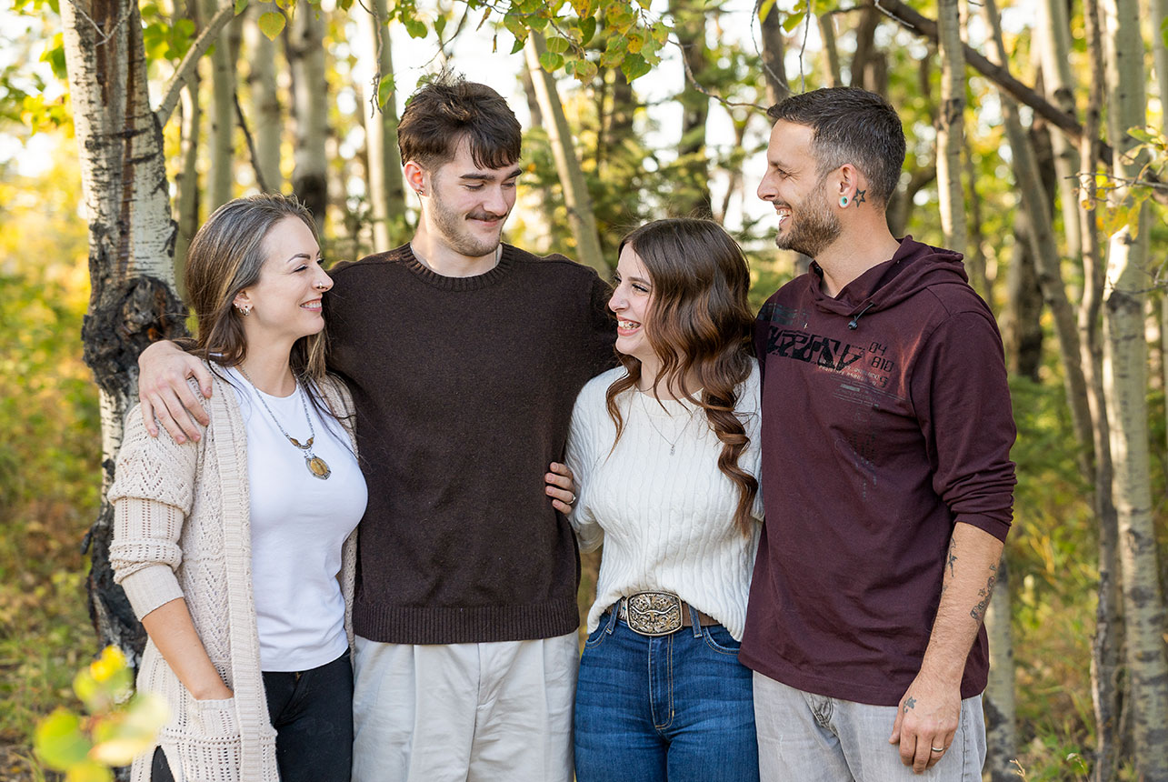 Parents and grown children sharing a natural moment together during an Edmonton area family photography session