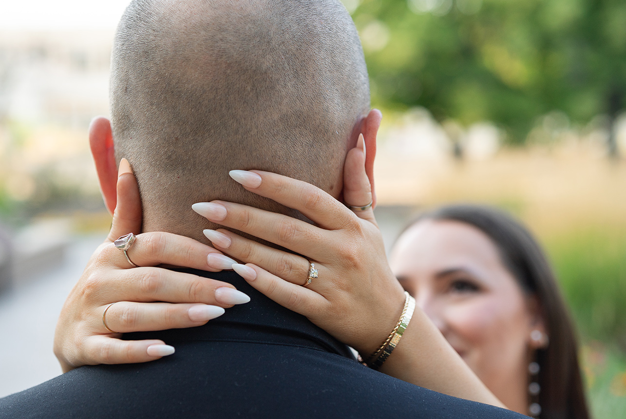 Close-up of a bride-to-be’s hands showing a ring and polished nails during an engagement session