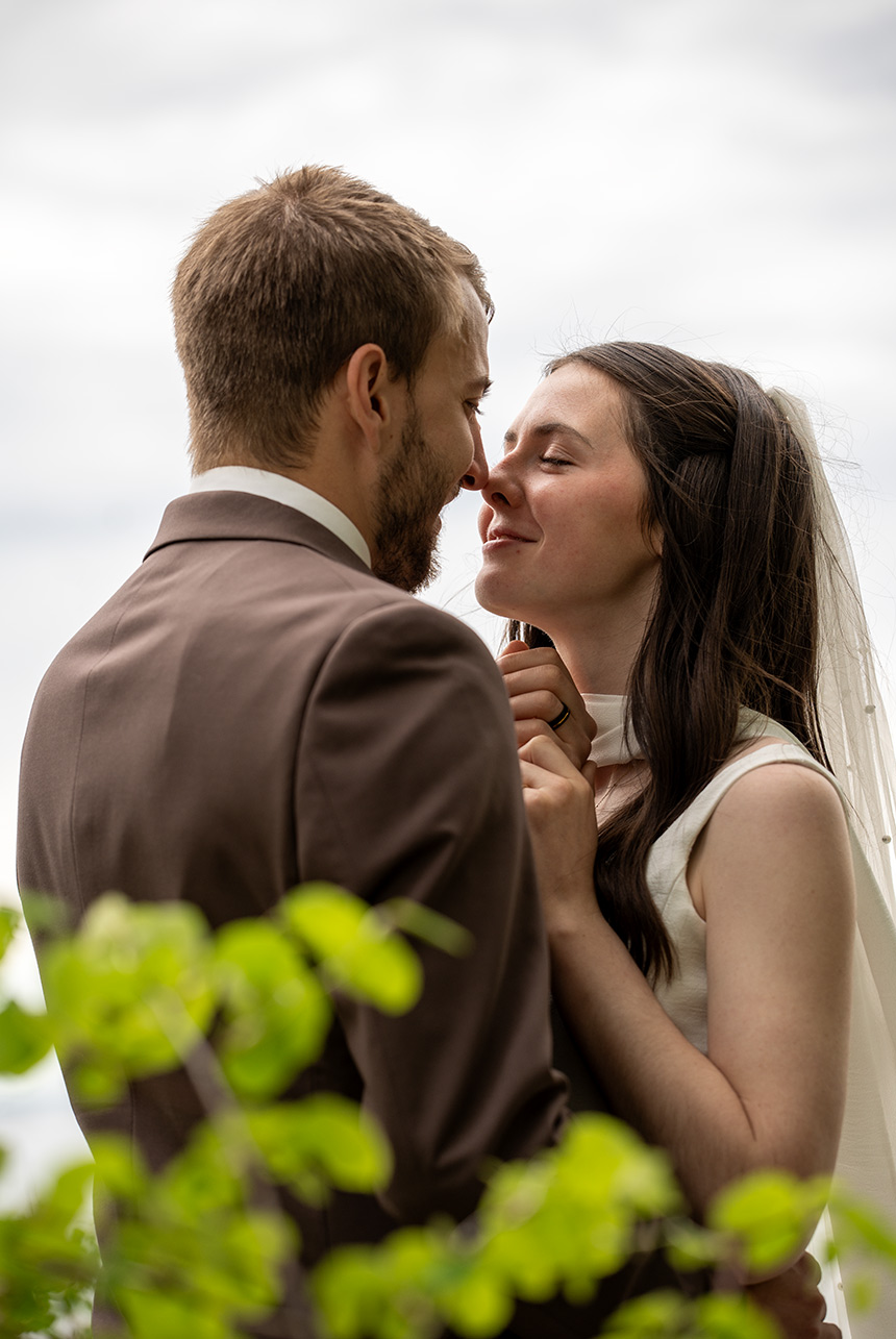 Bride and groom sharing a quiet emotional portrait after gentle wedding photography direction near the water