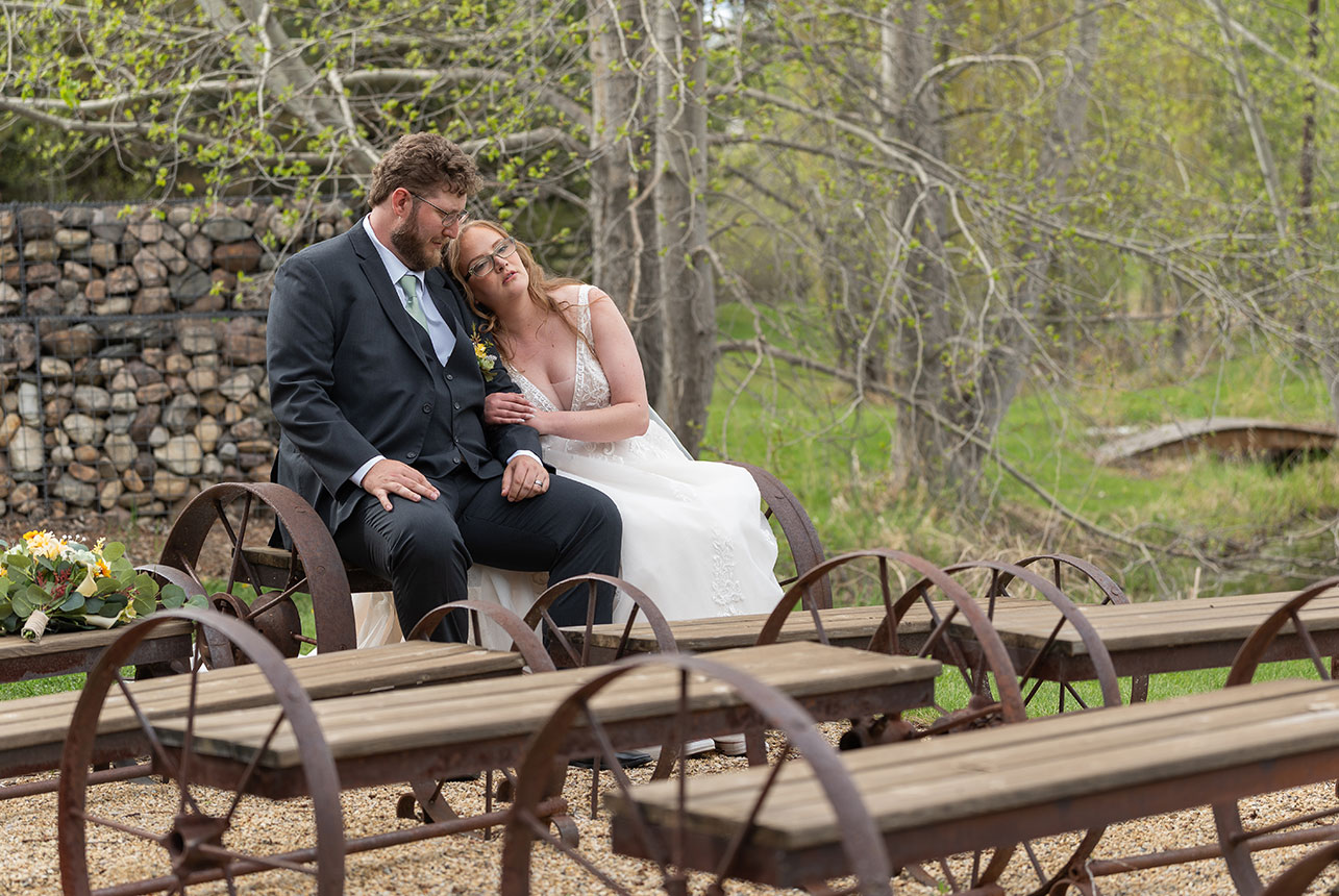 Bride and groom sharing a quiet seated portrait at Lions Garden