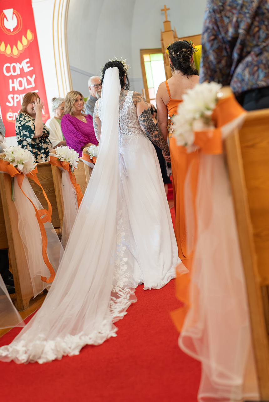 Bride entering the aisle during a wedding ceremony at St. Paul’s Lutheran Church in Rolly View.