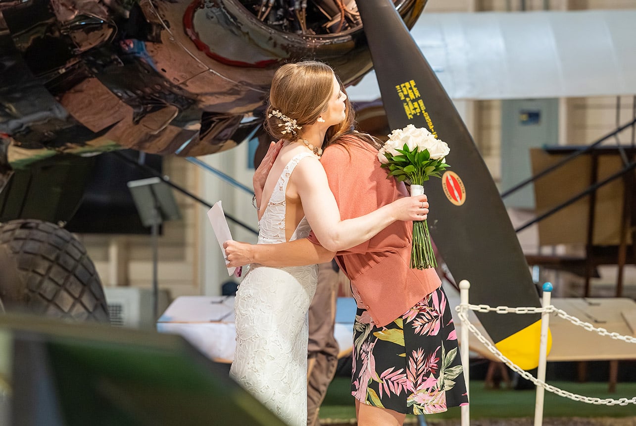 Bride hugging a loved one during her Alberta Aviation Museum wedding in Edmonton