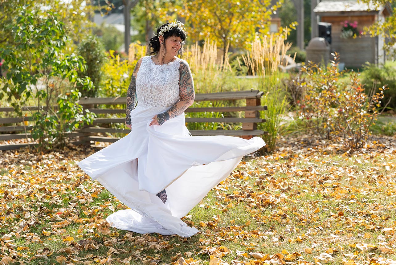 Bride twirling in her wedding dress at Stone Barn Garden in Leduc.