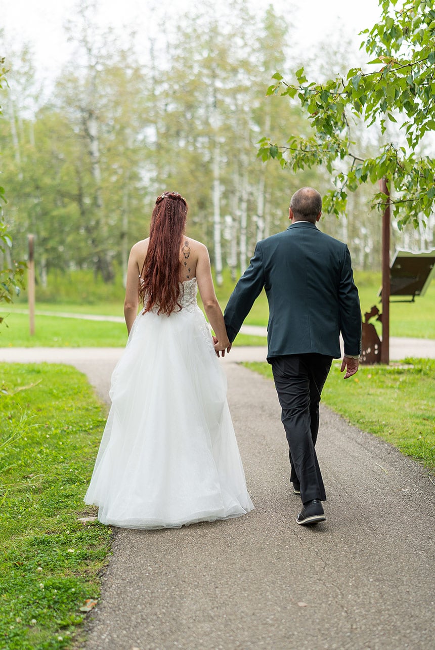 Bride and groom walking together after their Elk Island National Park wedding ceremony
