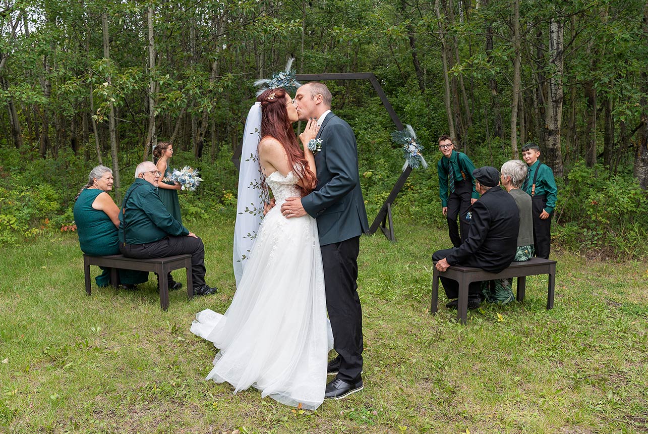 Intimate Elk Island National Park wedding ceremony surrounded by close family