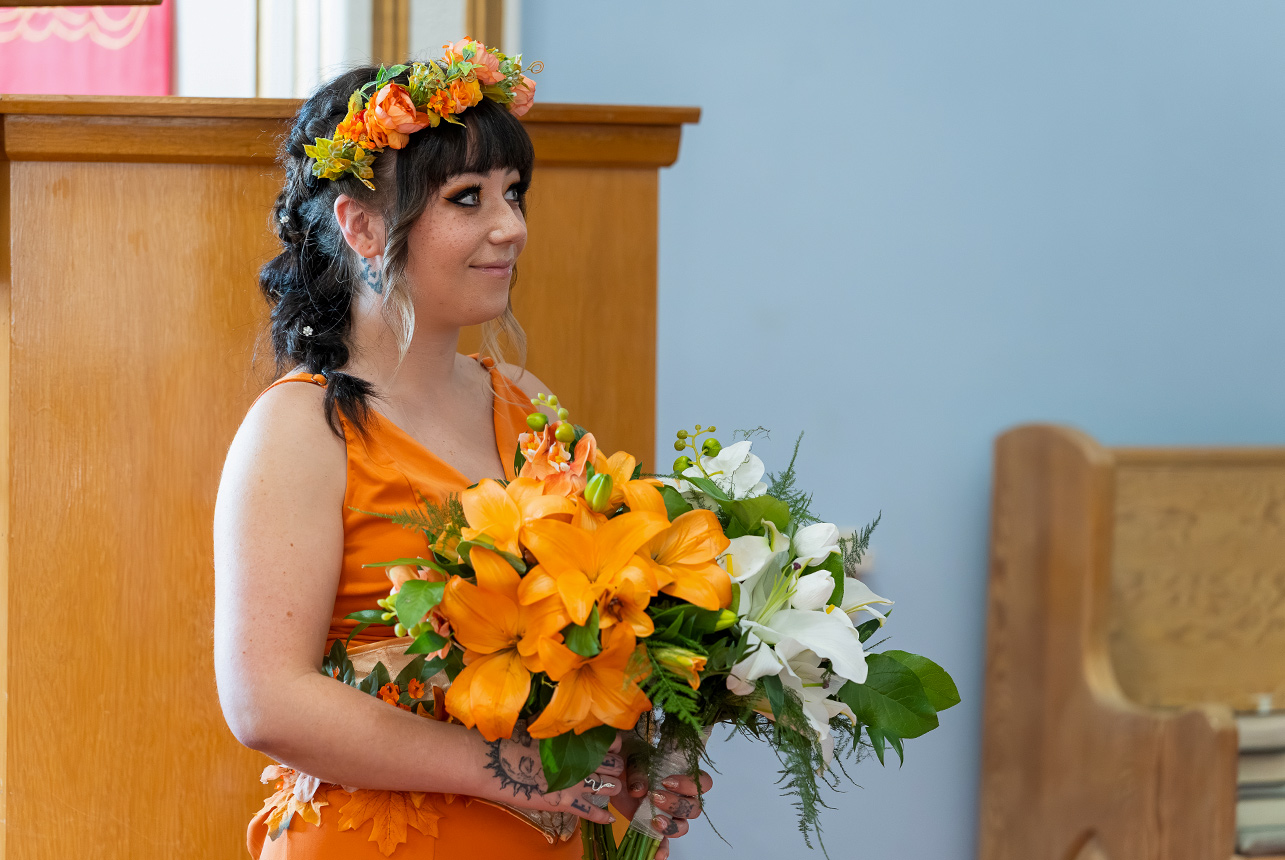 Orange and white wedding florals during a church wedding at St. Paul’s Lutheran Church in Rolly View.
