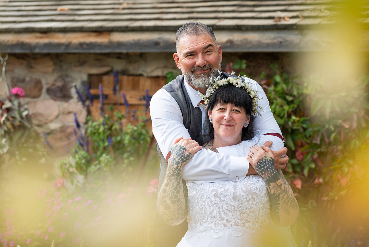 Trudy and Byron sharing a romantic portrait moment at Stone Barn Garden in Leduc.