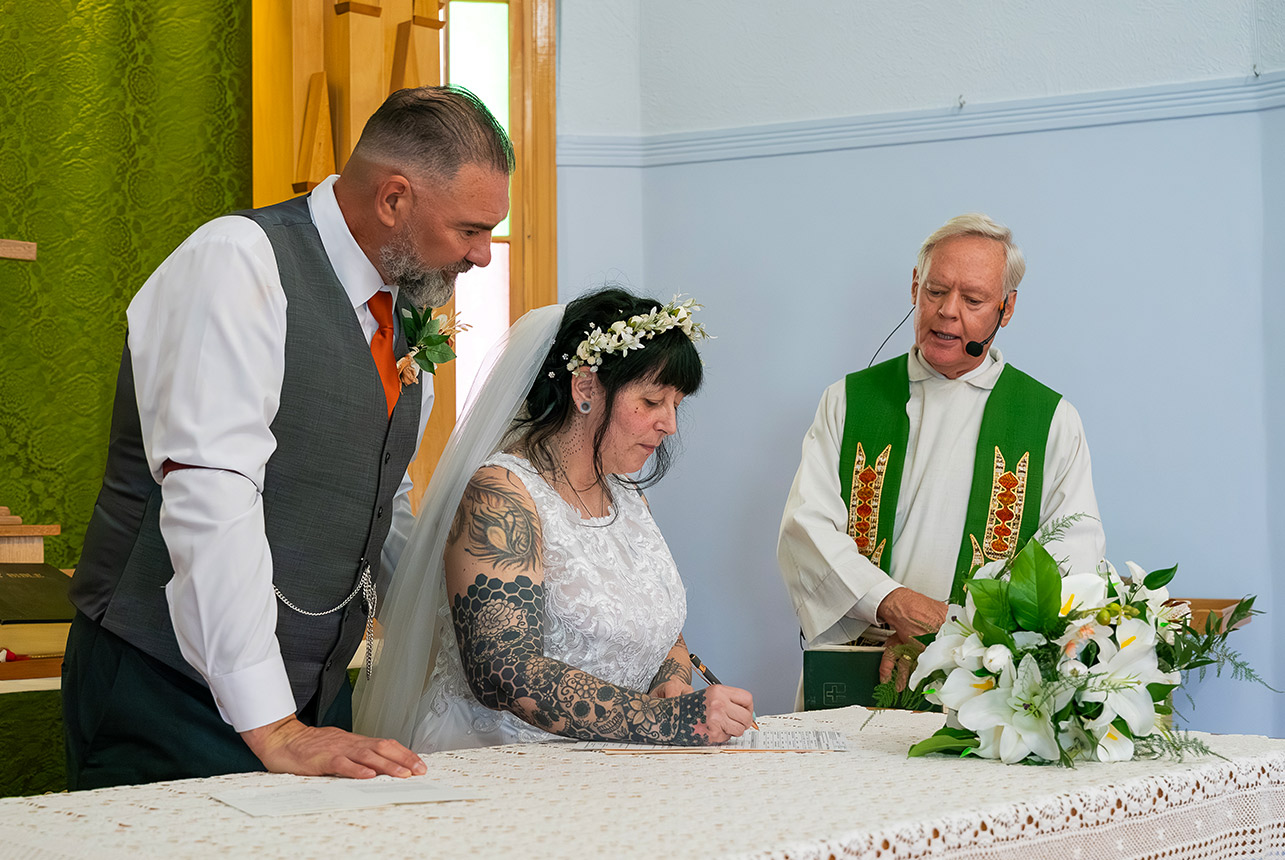 Trudy and Byron signing their wedding register inside St. Paul’s Lutheran Church in Rolly View.
