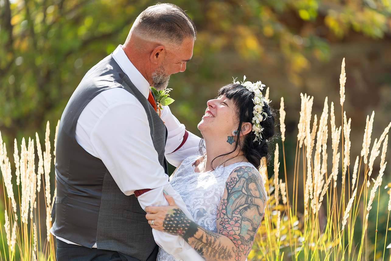 Trudy and Byron sharing a quiet wedding portrait moment at Stone Barn Garden and Cultural Village in Leduc.